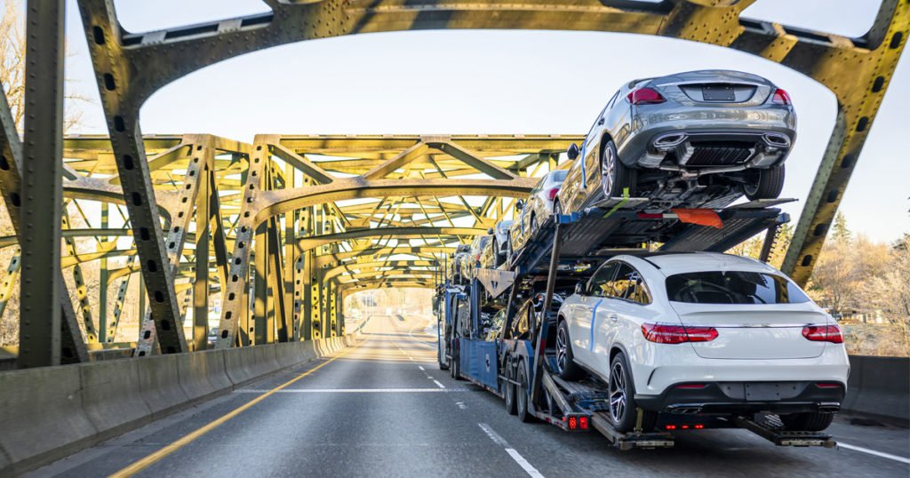 Enclosed car carrier transport with luxury vehicles